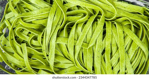 tagliatelle green color raw pasta basil vegetable food healthy meal food snack on the table copy space food background rustic top view - Powered by Shutterstock