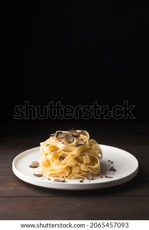 Tagliatelle pasta with black truffle mushrooms. Tagliatelle al tartufo - Italian autumn fresh recipe with black truffle, rustic minimalistic style, copy space for graphic design ストックフォト © 