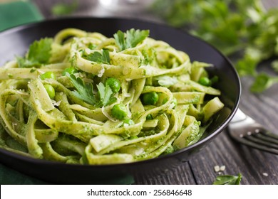 Tagliatelle pasta with spinach and green peas pesto, selective focus - Powered by Shutterstock