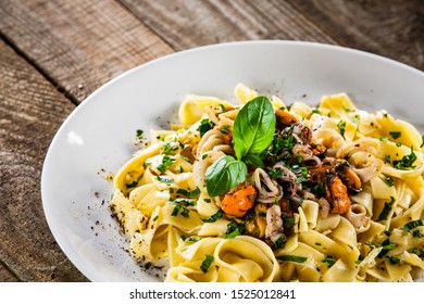 Tagliatelle With With Seafood On White Plate