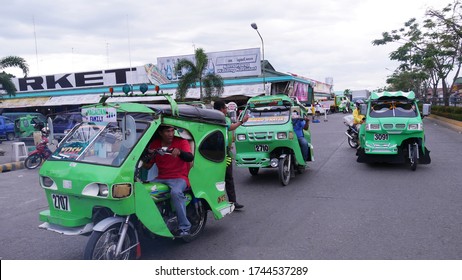 Tagum City, Philippines- March 2016: Tricycles, or improvised motorcycles with side cars are one of the modes of transportation in the southern Philippines.