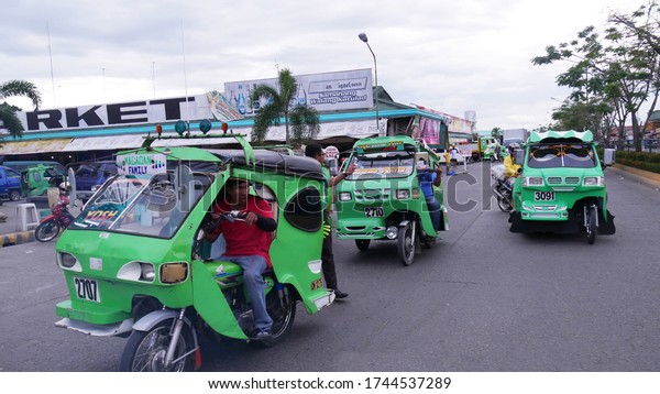 Tagum City, Philippines- March\
2016: Tricycles, or improvised motorcycles with side cars are one\
of the modes of transportation in the southern\
Philippines.