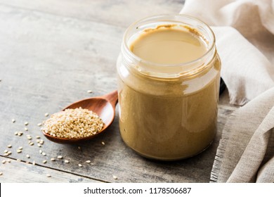 Tahini And Sesame Seeds On Wooden Table. 
