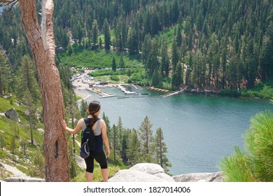 Tahoe, CA / USA - September 5, 2019:  A Woman Looking At A Lake After Hiking Uphill. 