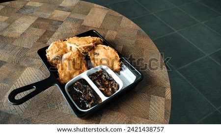 tahu walik with soy sauce. Dried tofu is processed into a delicious snack that is often available in modern cafes. top view. indoors