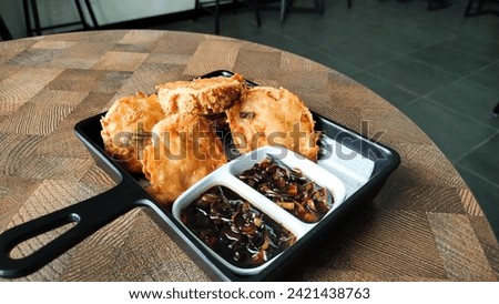 tahu walik with soy sauce. Dried tofu is processed into a delicious snack that is often available in modern cafes. top view. indoors