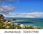 Tahunanui Beach in Nelson, New Zealand. Rainbow visible in the distance.