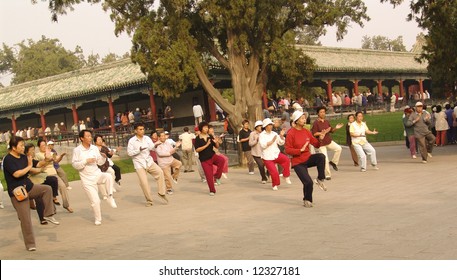 Tai Chi Exercising In The Morning In Beijing, China In The Temple Of Heaven Park