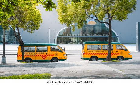 Taichung / Taiwan - April 18 2019 : The two yellow school buses park beside the street near National Taichung Theatre building.