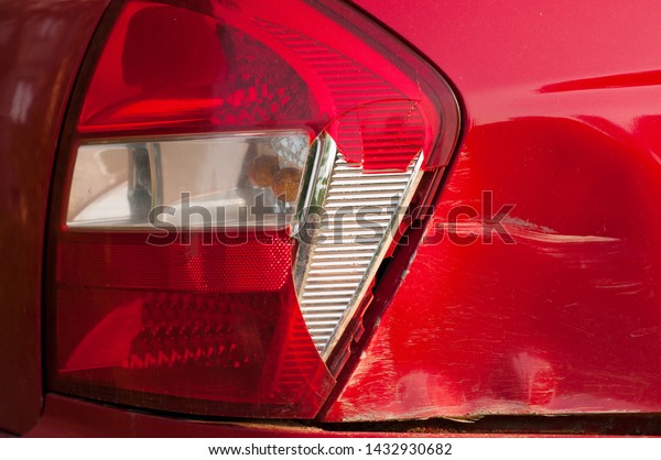 tail light car.\
broken rear brake light. red passenger car. dent and scratch on the\
rear fender. road accident