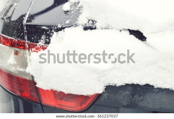 Tail\
light.Ice on the car light.Car under the\
snow