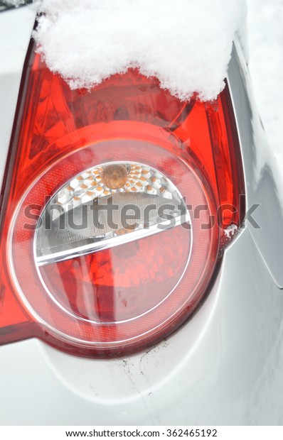 Tail\
light.Ice on the car light.Car under the\
snow