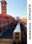 The tail of passing away train from the platform of the old historic rail station with a number of brick buildings and tower and the inscription Union Station in heart of Portland, Oregon Down Town 