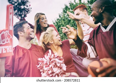 Tailgating: College Student Fans Give High Five For Team Win