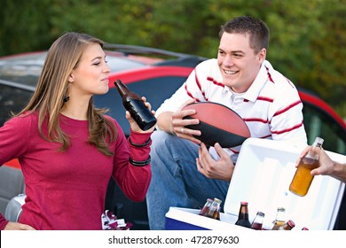 Tailgating: Friends Having Drinks From Cooler At Tailgate Party