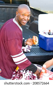 Tailgating: Male Student Getting Food From Table