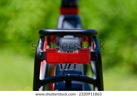 Similar – Image, Stock Photo Red bicycle luggage rack and rear light