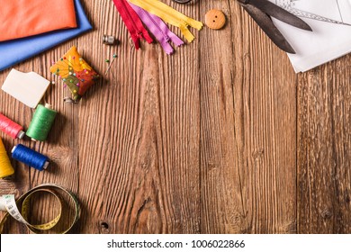 Tailor accessories. Concept. Natural wooden background. View from above.