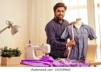 Tailor Asian Man Designer Sewing Clothes On Sewing Machine Next To Laptop Studio Workplace