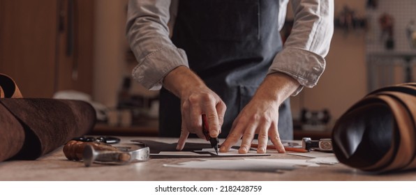 Tailor cobbler hold different rolls natural brown leather, working with textile in workshop. - Shutterstock ID 2182428759