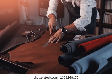 Tailor cobbler use natural brown leather, shoemaker working with skin textile in workshop. - Powered by Shutterstock