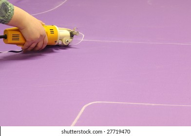 Tailor cutting fabric by using electric scissors