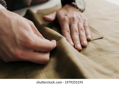 Tailor man working in his tailor shop, individual tailoring - Powered by Shutterstock