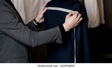 Tailor measuring business man for suit. self-employed. manufacturing