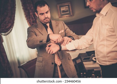 Tailor Measuring Client For Custom Made Suit Tailoring