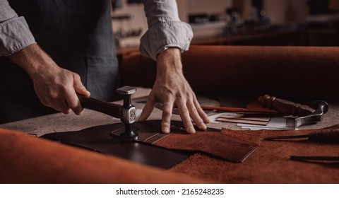 Tailor processing hammers seam on leather goods, Handmade craftsman.