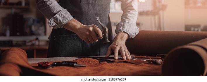 Tailor processing hammers seam on leather goods, Handmade craftsman. - Shutterstock ID 2188976289