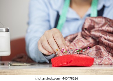 Tailor Removing Pin From Cushion In Sewing Factory - Powered by Shutterstock