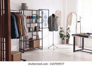 Tailor shop interior with mannequin and male suits on rack - Powered by Shutterstock