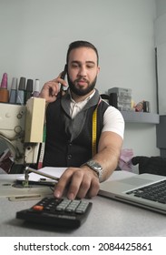 Tailor Shop Owner Calculating Monthly Reports, Bills And Expenses Of His Small Business.  Small Entrepreneurship