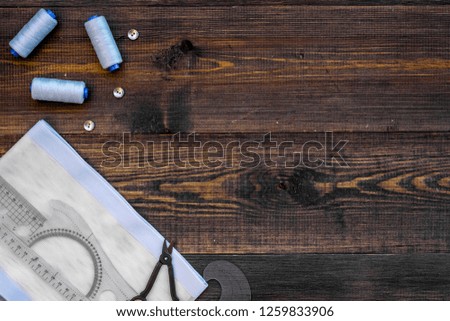 Tailor shop with thread, scissors, fabric. Sewing as hobby. Wooden background top view mockup