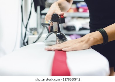 Tailor Using Ironing Steam. The Steam Generator.