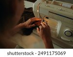 Tailor Using Sewing Machine At His Work