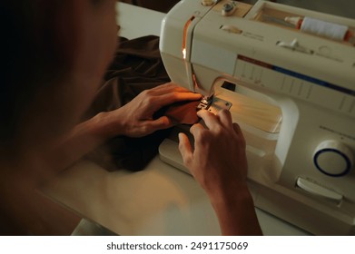Tailor Using Sewing Machine At His Work