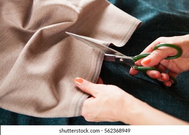 Tailor. Woman Hands notch tailor tailor's scissors cloth. Close Up.  