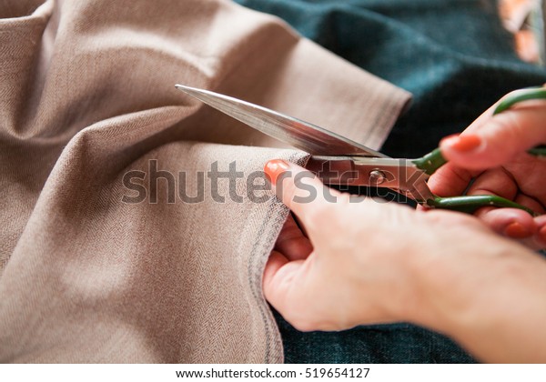 Tailor. Woman Hands notch tailor tailor\'s scissors\
cloth. Close Up.  