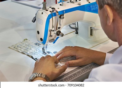 Tailor at work with a sewing machine