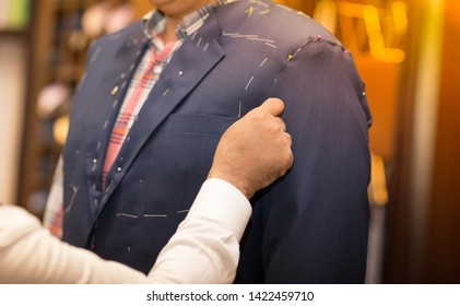 Tailor Working With Custom Made Suit