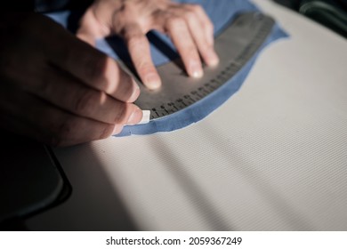 tailor working with sewing pattern in atelier