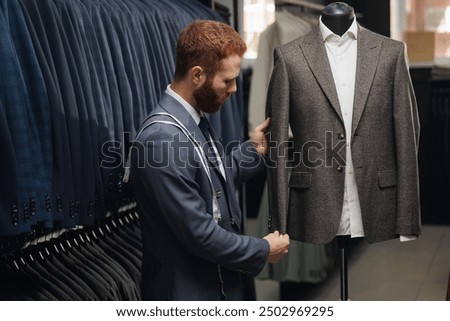 Tailor working with suit to custom size for man, hand made fashion jacket, store for men.