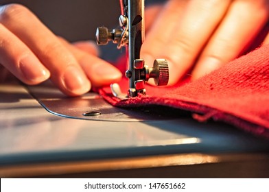 Tailoring Process - Women's hands behind her sewing - Shutterstock ID 147651662