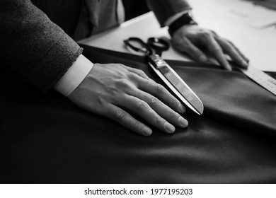 tailor's hands on the fabric. custom tailoring of products. tools for cutting clothing material - Powered by Shutterstock