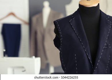 Tailor's mannequin with half-made jacket in atelier