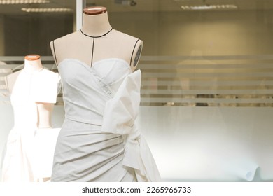 Tailor's textile female mannequin with black lines covered with canvas fabric pattern and draping for dressmakers working and designing new fashion collections in an atelier tailor workshop.