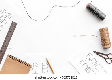 Tailor's work desk. Pattern of clothing and tools on white background top view copyspace - Powered by Shutterstock