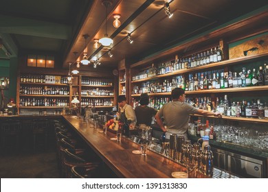 Tainan City, Taiwan - April 19th, 2019: The interior of Bar named "Bar Home", one of good bars in Tainan City, Taiwan. People are talking and drinking wine or drinks in this bar.